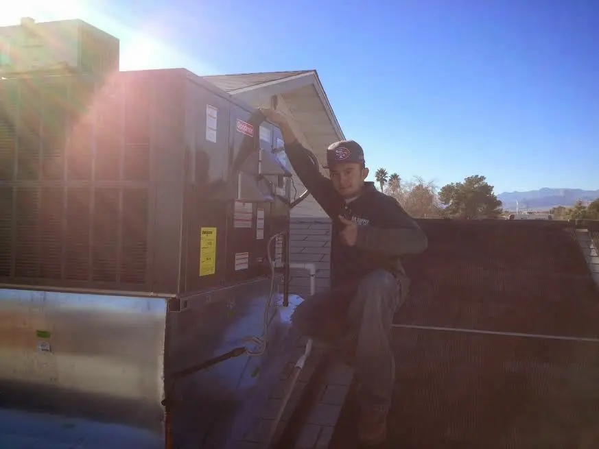 HVAC technician performing AC Tune-Up on a rooftop unit in Vero Beach South